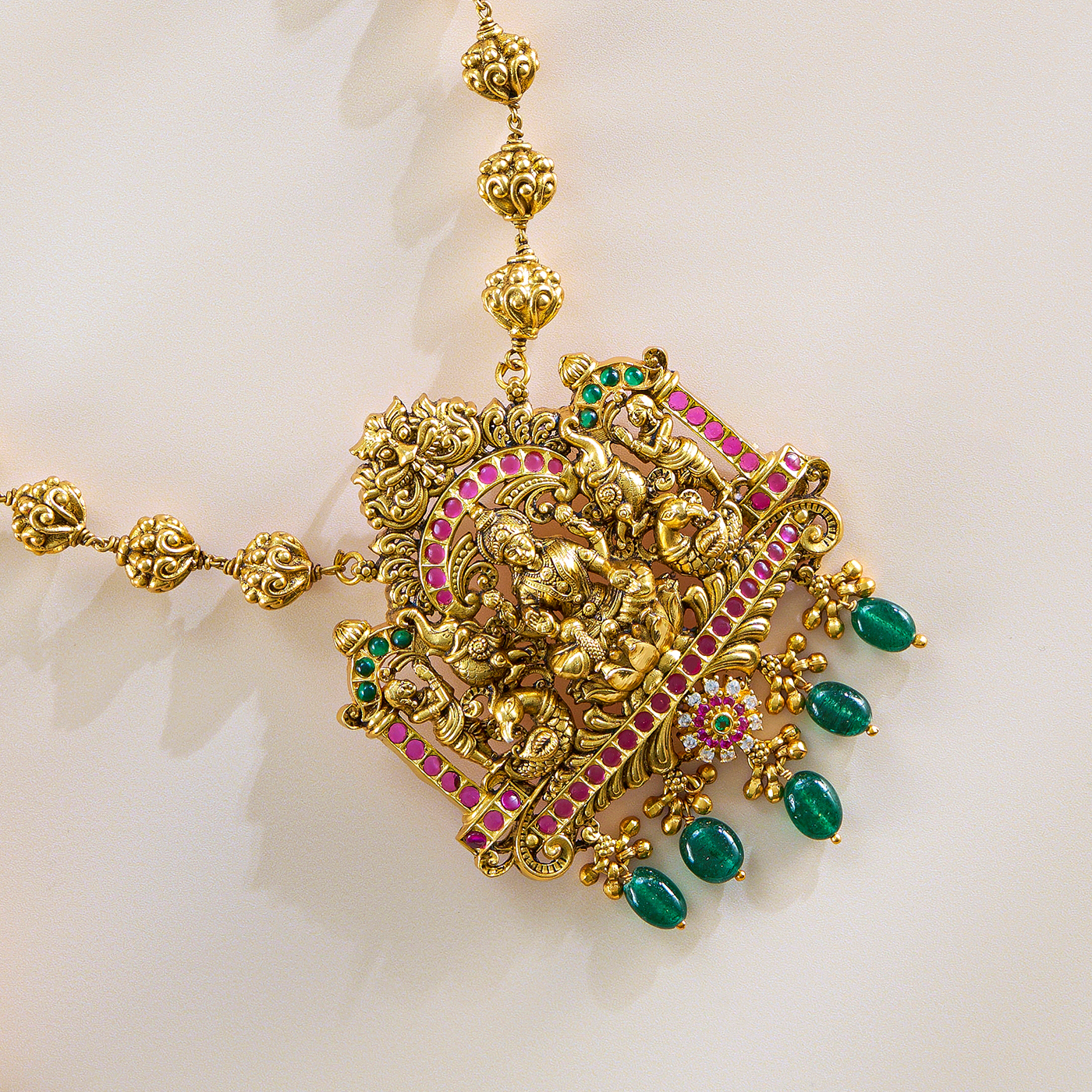 Lakshmi Temple Pendant Set in Antique Gold with Green Drops