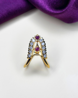 A gold ring with three round purple gemstones and clear accent stones.