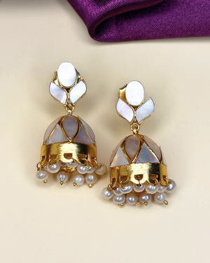 A pair of gold-plated jhumka earrings with iridescent white mother-of-pearl.