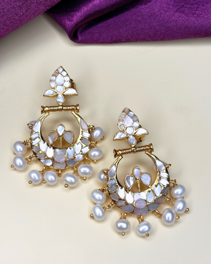 A pair of gold-plated Indian style dangle earrings decorated with white faux pearls.