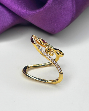 A gold snake ring with a central red gemstone.