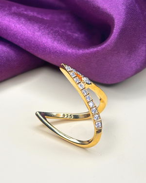 A gold-plated triangular open ring adorned with clear cubic zirconia stones on one side.