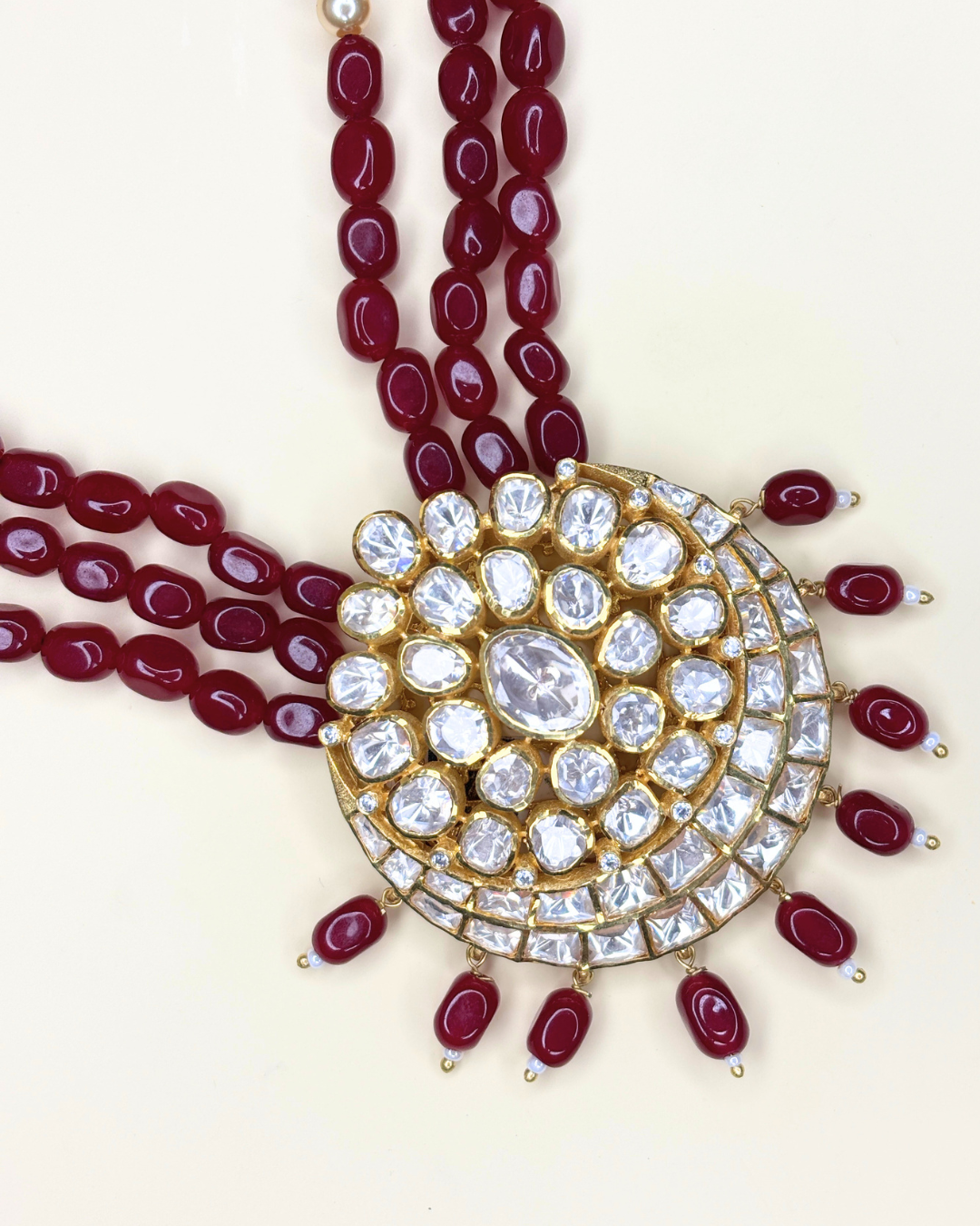 A traditional Indian Kundan necklace featuring a large gold-plated circular pendant.