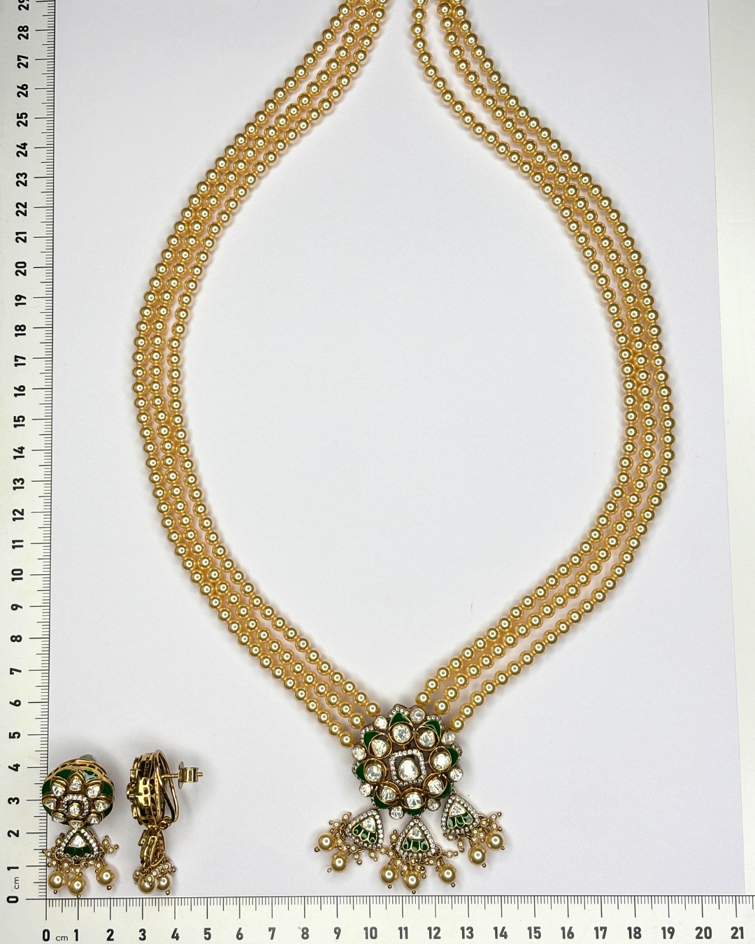 A gold-toned traditional Indian jewelry set consisting of a double-strand necklace.