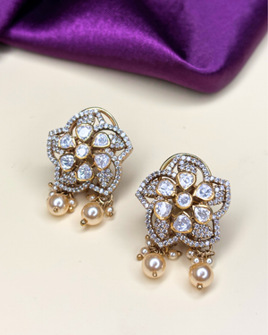 A pair of gold-toned floral chandelier earrings adorned with clear stones.