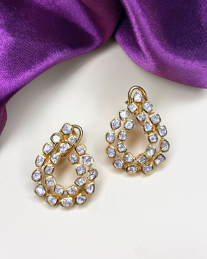 A pair of gold teardrop-shaped earrings.